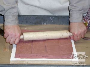 לחיצה להגדלת תמונה מרדדים את החימר במארוך כדי ליצור עובי אחיד.