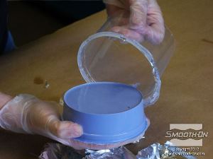 לחיצה להגדלת תמונה מוציאים בזהירות את תבנית הסיליקון ליציקה Oomoo® 30 ממיכל הפלסטיק.