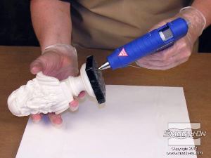 לחיצה להגדלת תמונה מדביקים את המודל ללוח הבסיס בעזרת דבק חם, כדי למנוע ממנו לזוז במהלך תהליך הכנת התבנית.